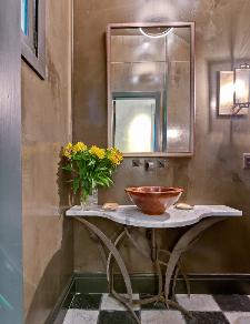 Powder Room tucked under stairway with antique marble flooring